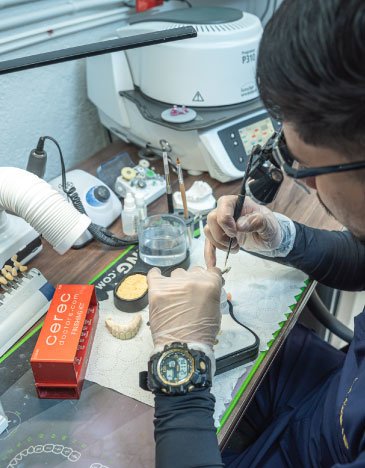 A dental technician works on a restoration in the OG Center laboratory